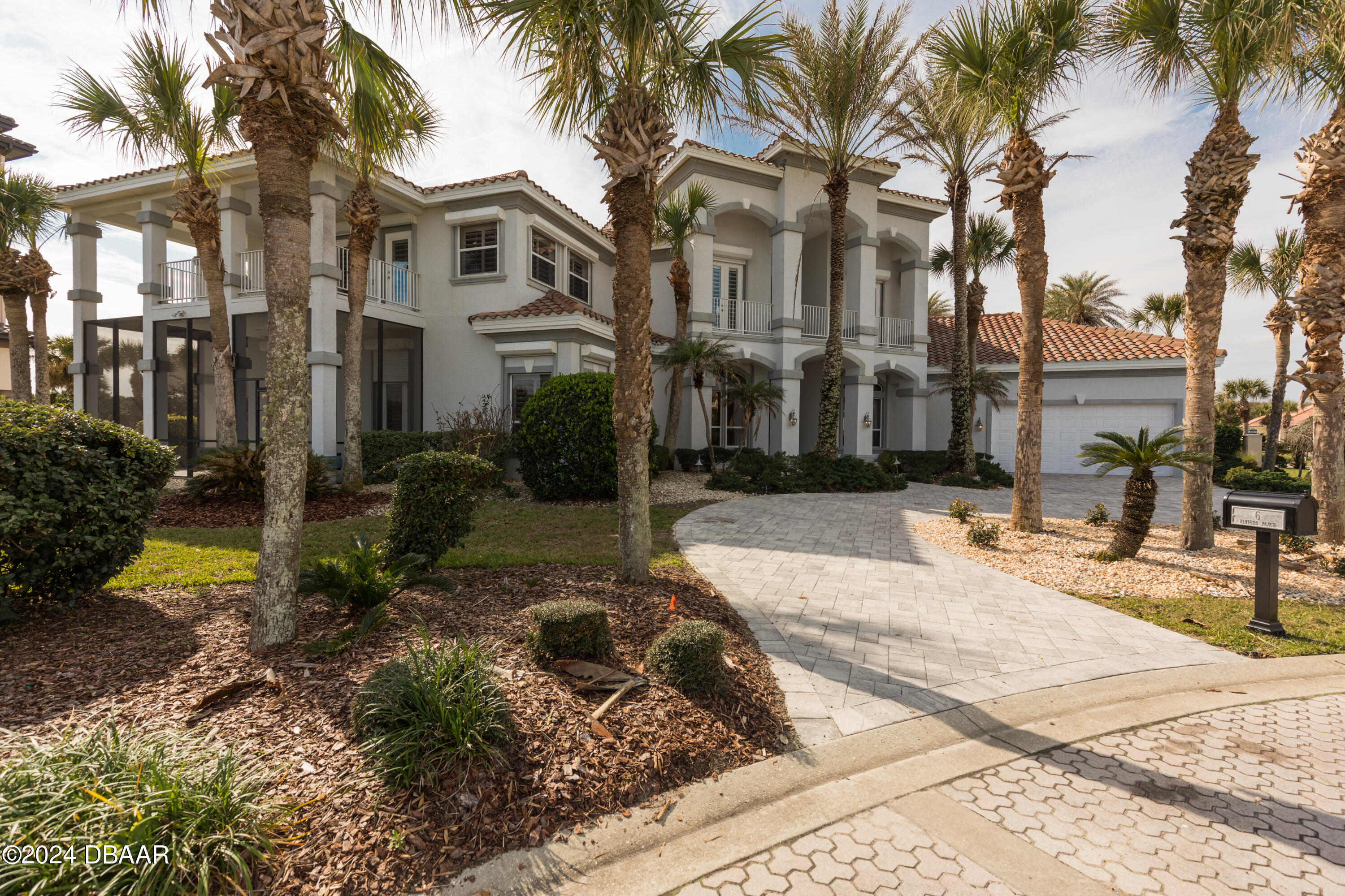 a view of a building with a yard and palm trees