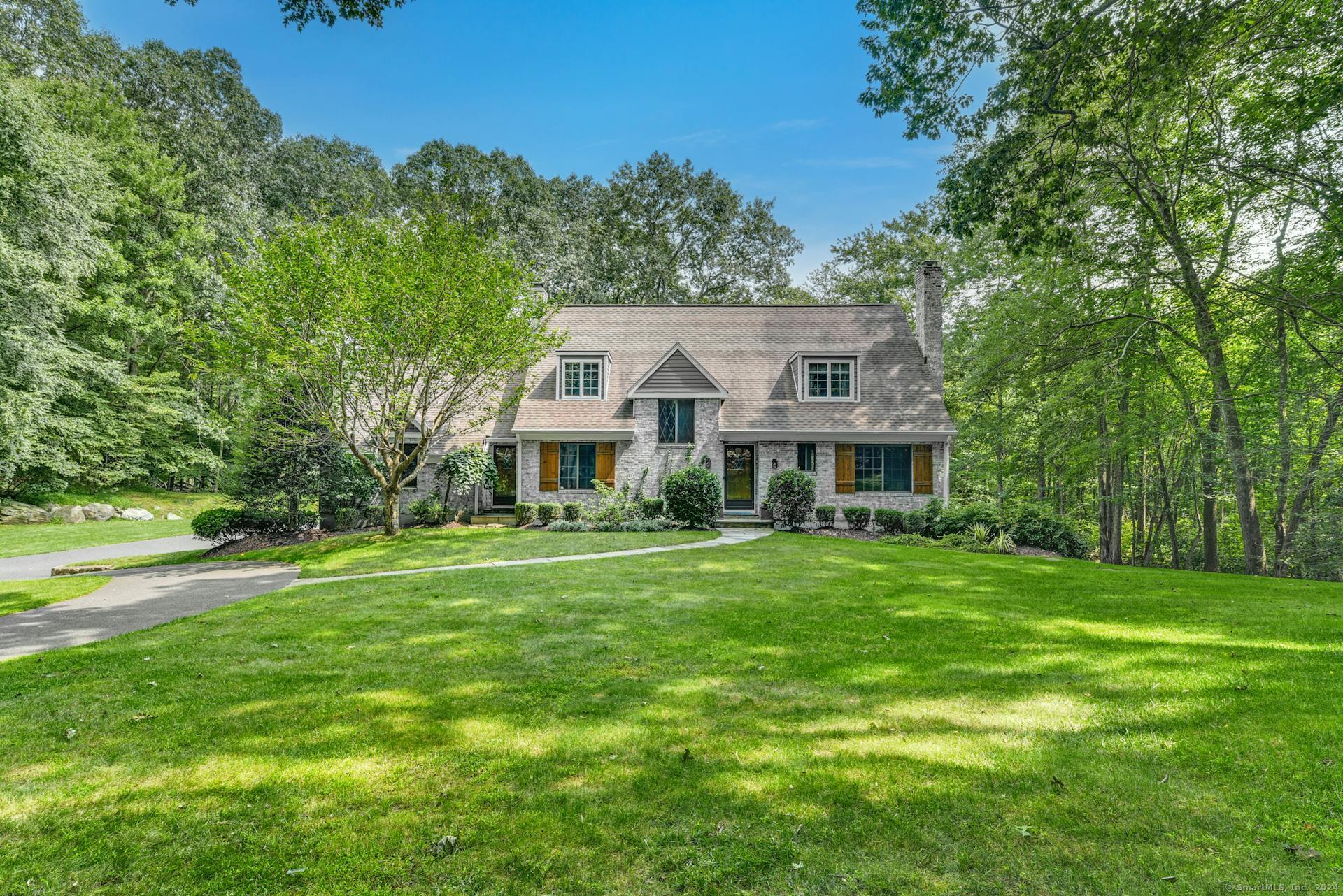 Emerald green front lawn, mature landscape.