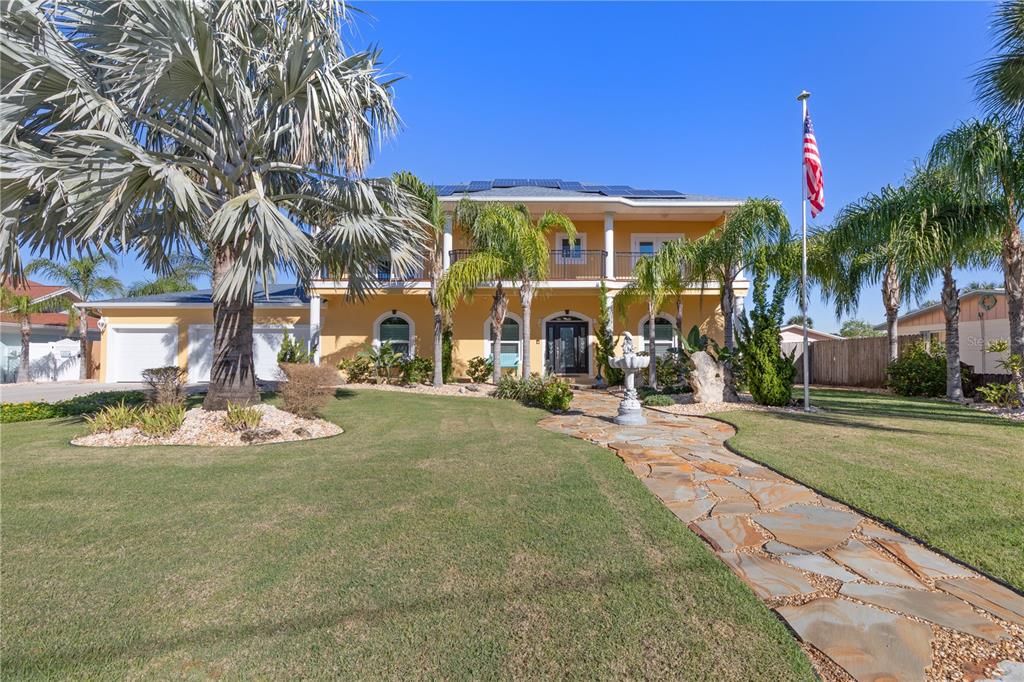 a row of palm trees sitting in front of a house