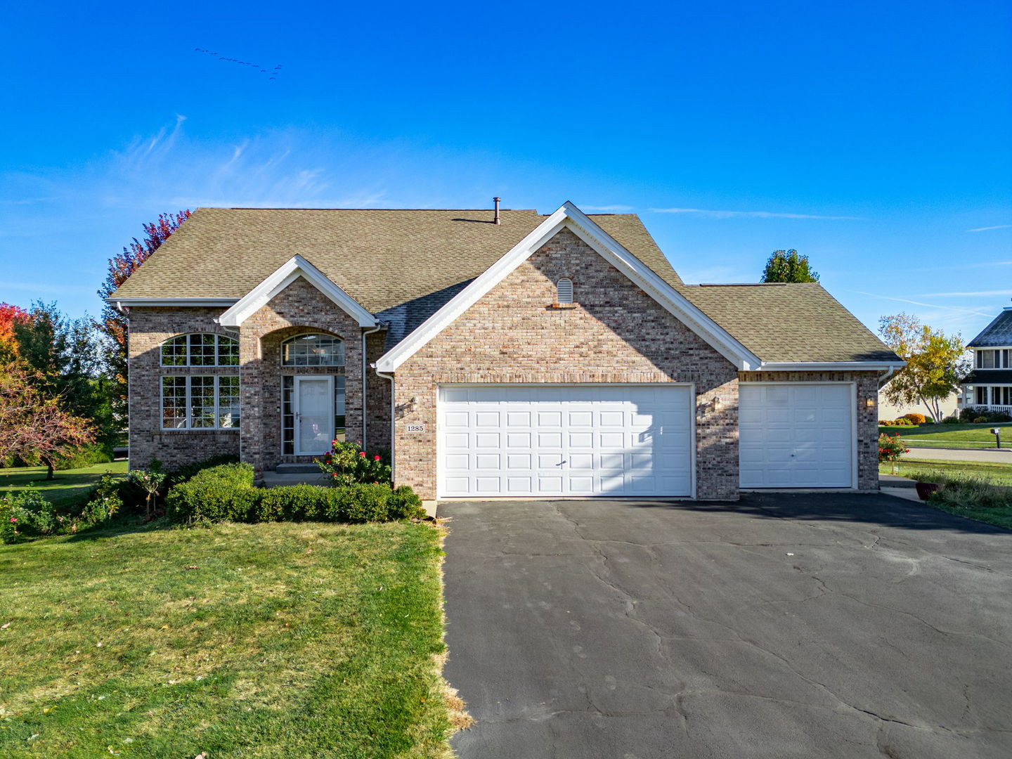 a view of a house with a yard and garage