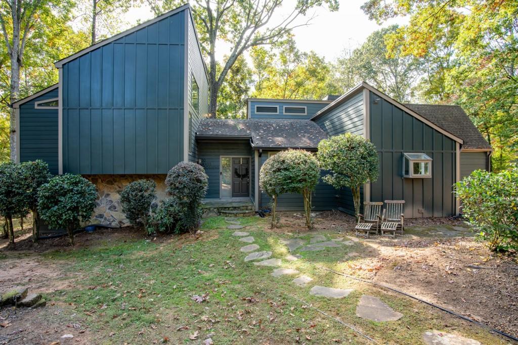 a backyard of a house with plants and tree