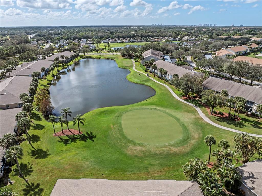 an aerial view of a residential houses with outdoor space and a lake view