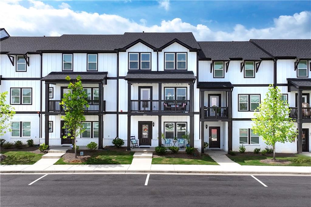 a front view of a residential apartment building with a yard