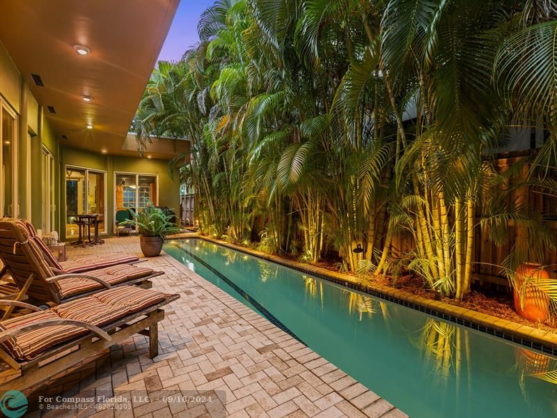 a swimming pool with outdoor seating and yard