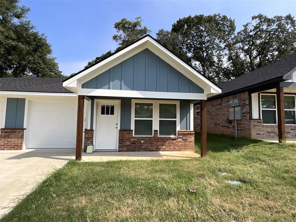 a front view of a house with a garden and porch