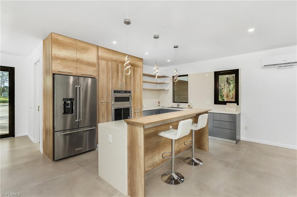 a kitchen with stainless steel appliances a refrigerator and microwave