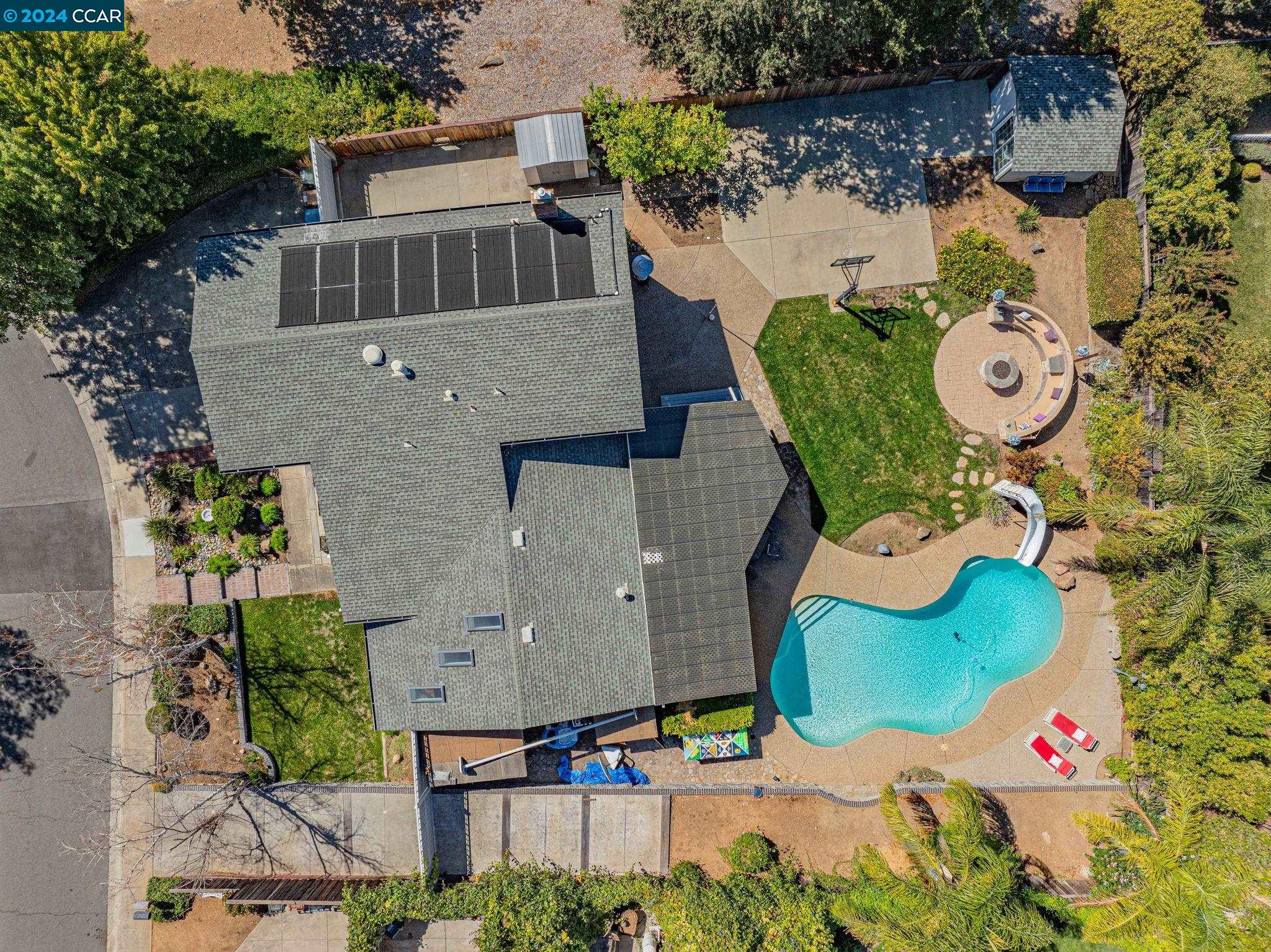 an aerial view of a house with swimming pool and outdoor space