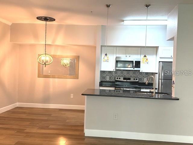 a kitchen with kitchen island a counter space a sink and appliances