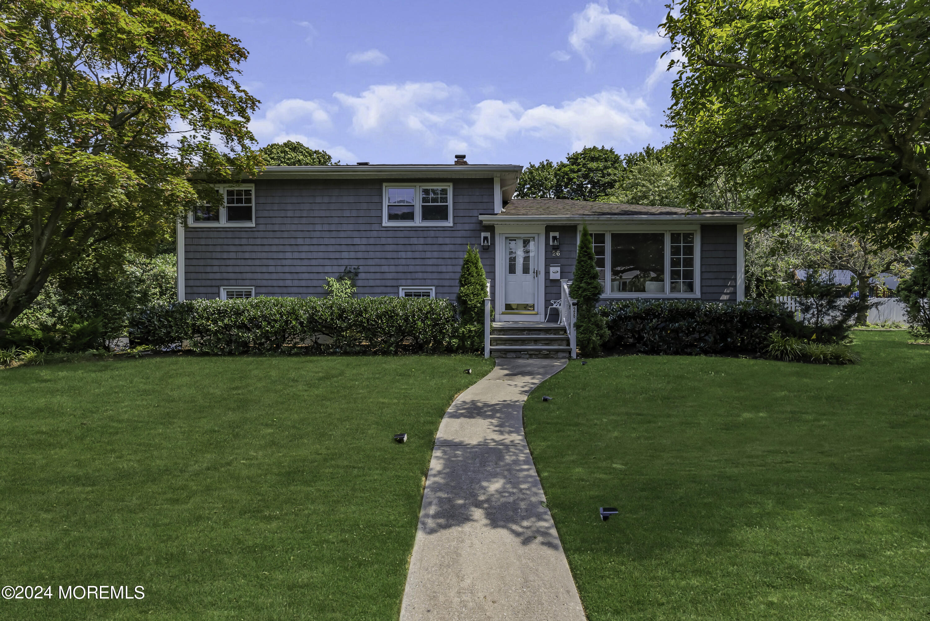 a front view of a house with a garden