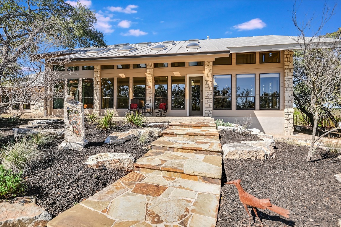 a front view of a house with a yard outdoor seating and barbeque oven