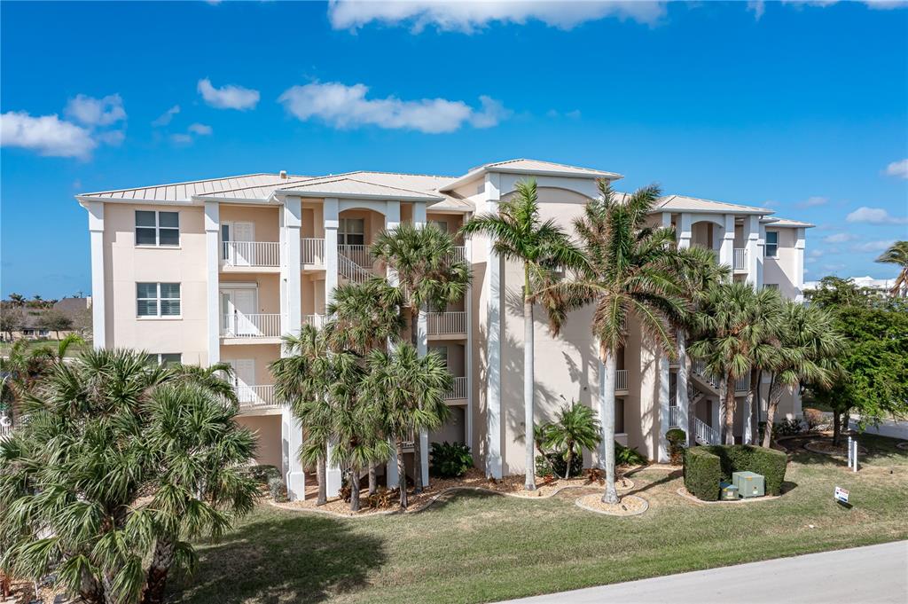 a front view of a residential apartment building with a yard