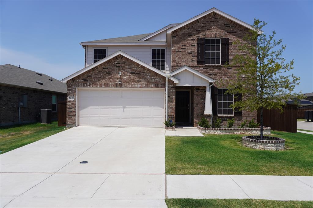 a front view of a house with a yard garage and outdoor seating