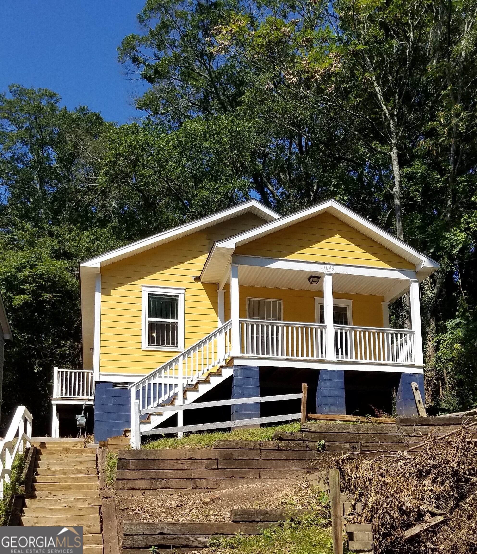 a front view of a house with a garden