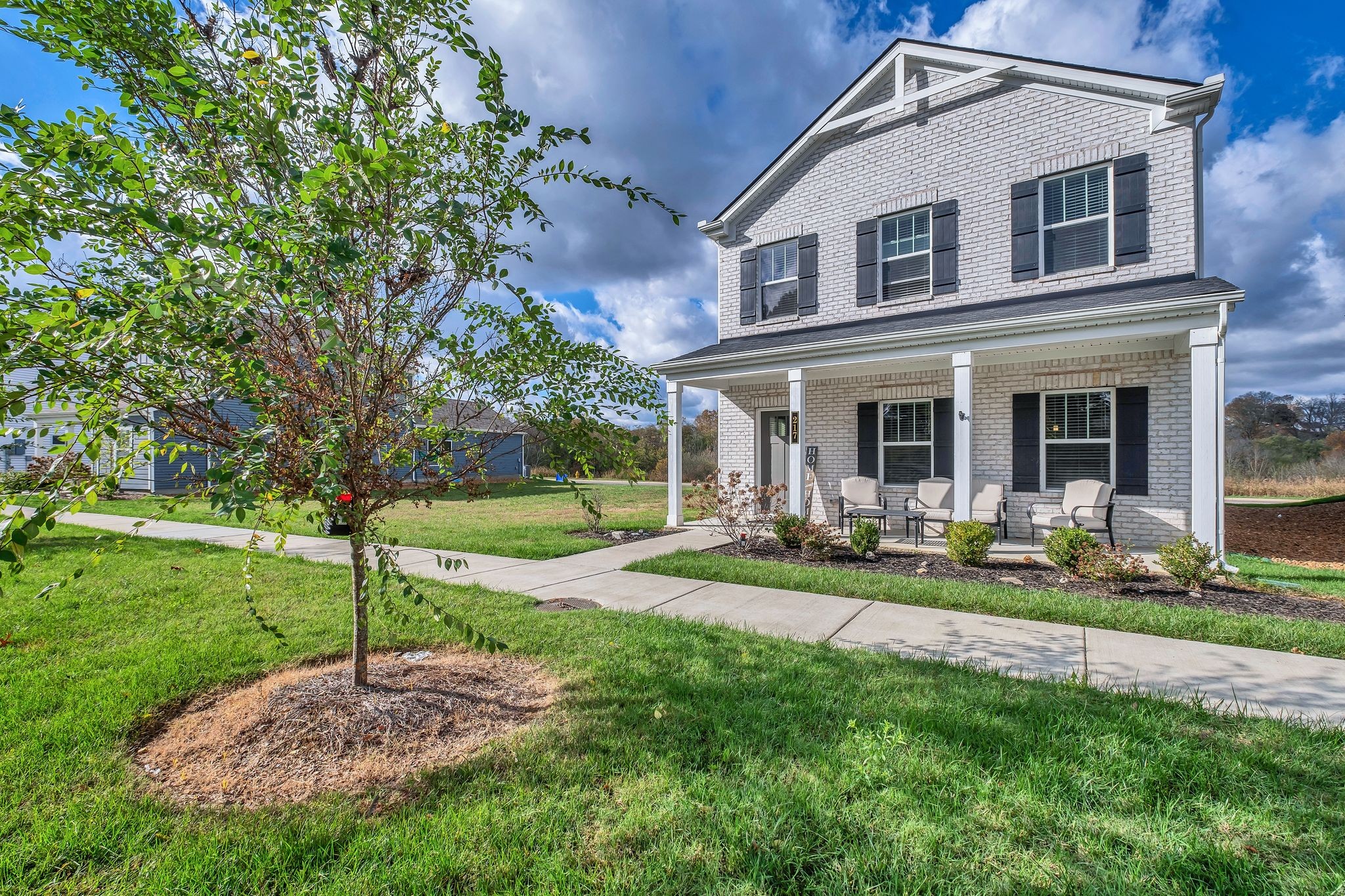 a view of a house with a yard porch and sitting area