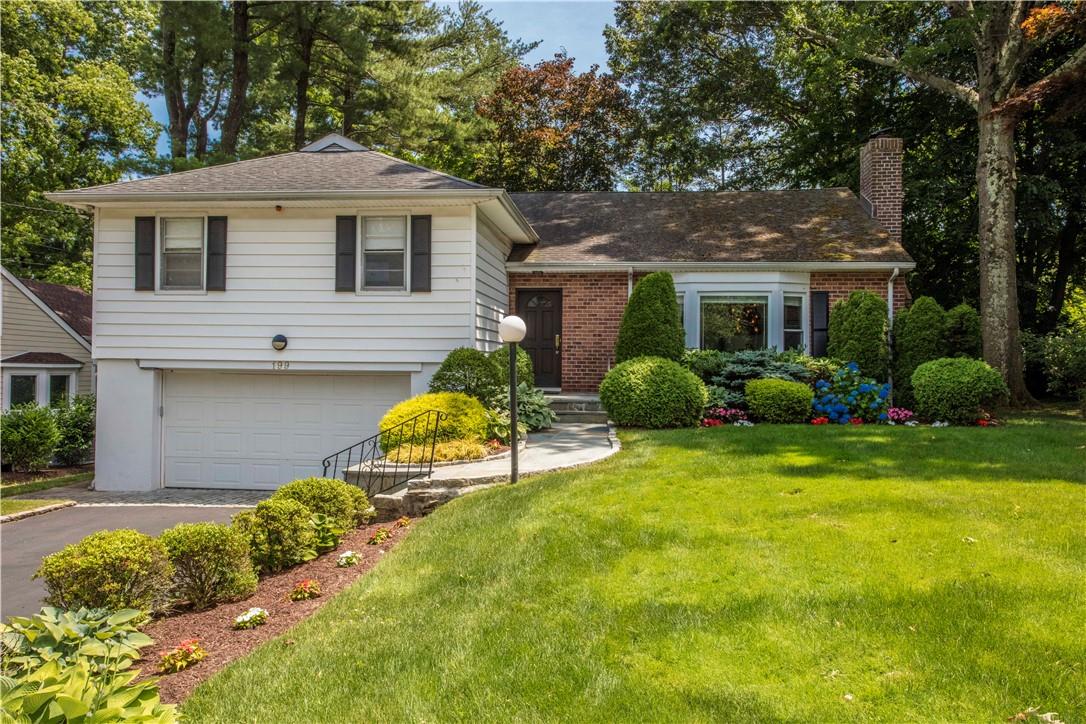 a front view of house with yard and green space