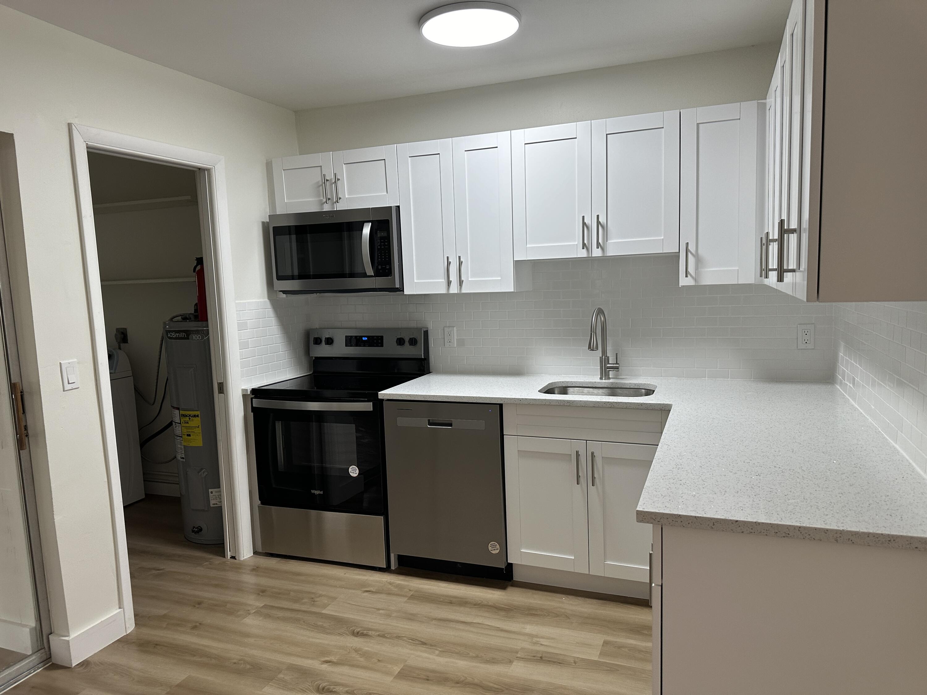 a kitchen with a sink cabinets and stainless steel appliances