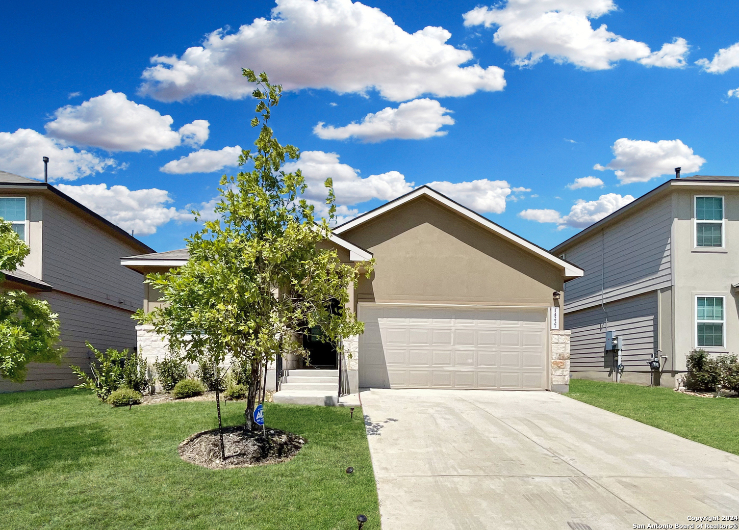 a front view of a house with a yard