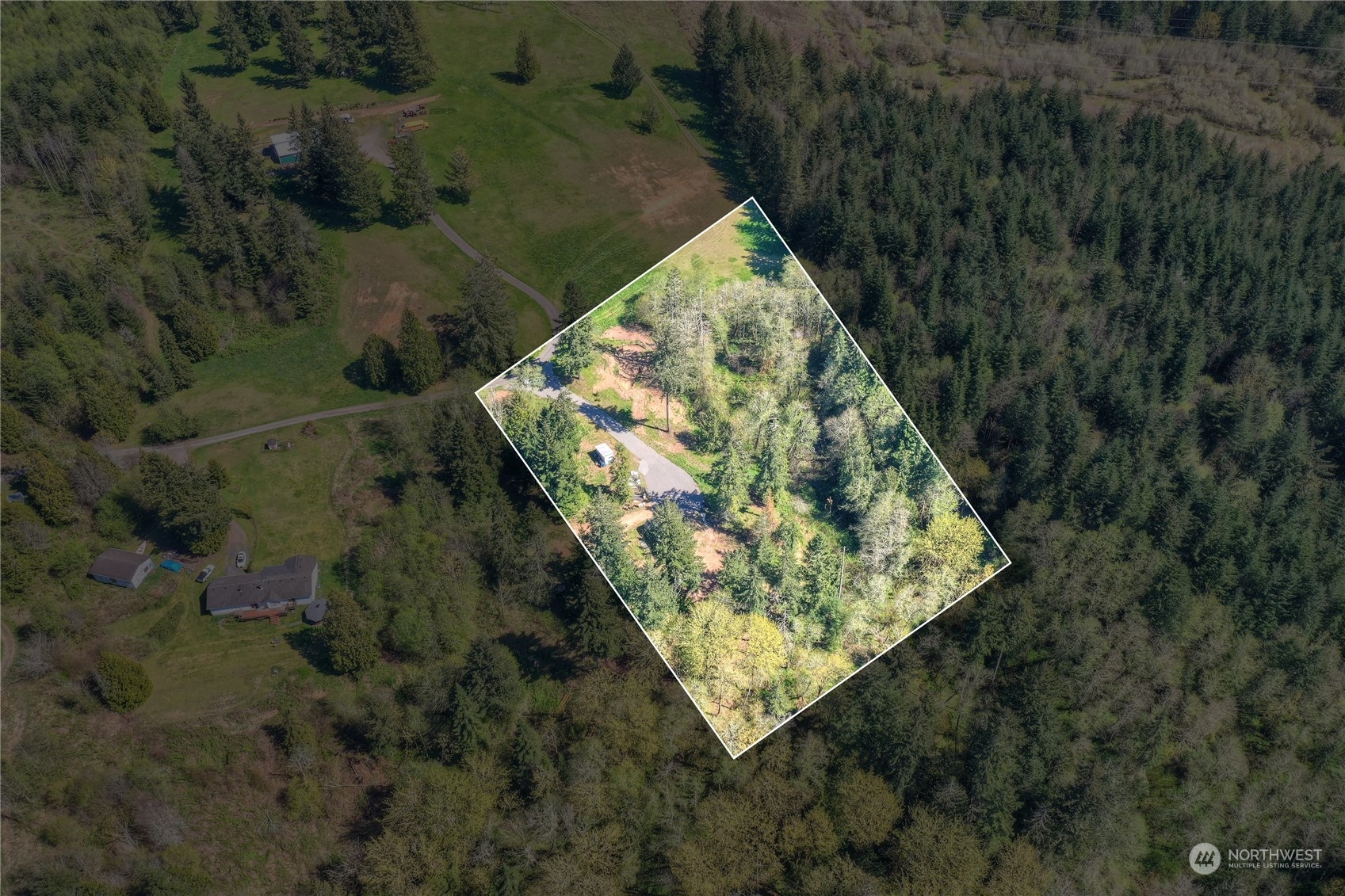 an aerial view of a house with a yard