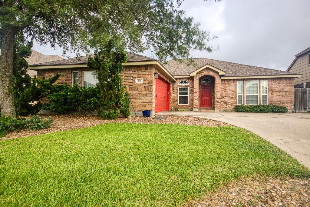 a front view of a house with a yard and garage