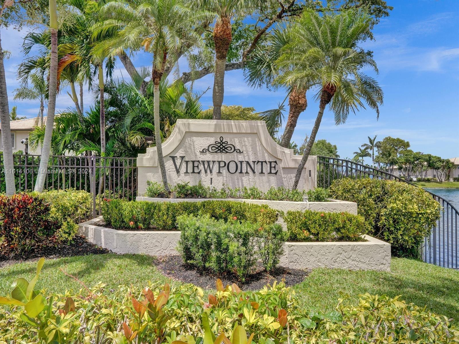 a view of a sign under a palm tree