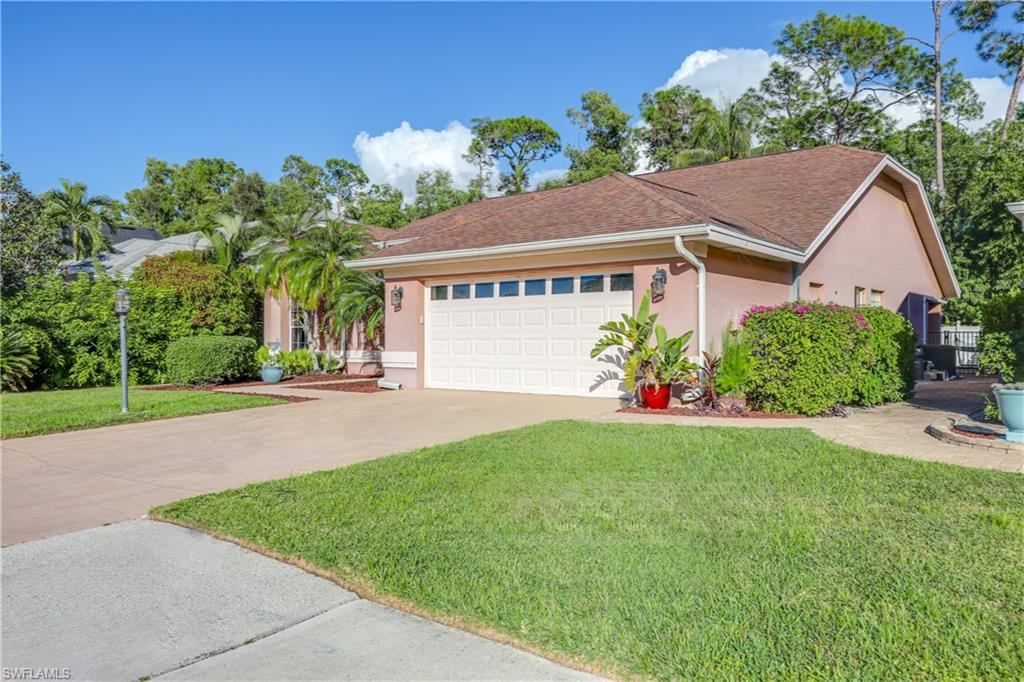 a house with green field in front of it