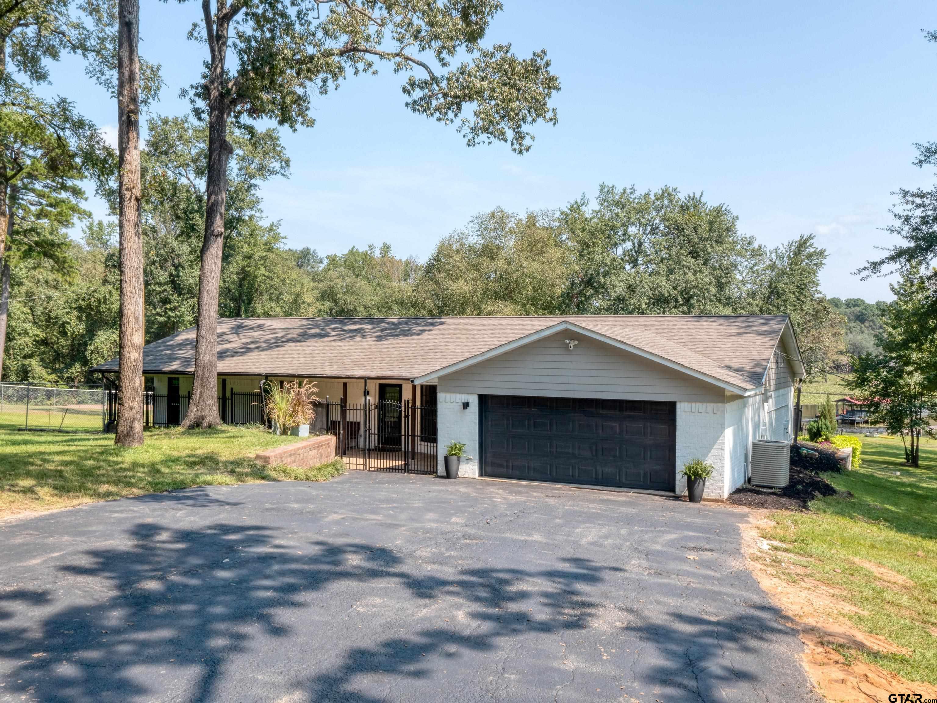 a front view of a house with a yard and trees