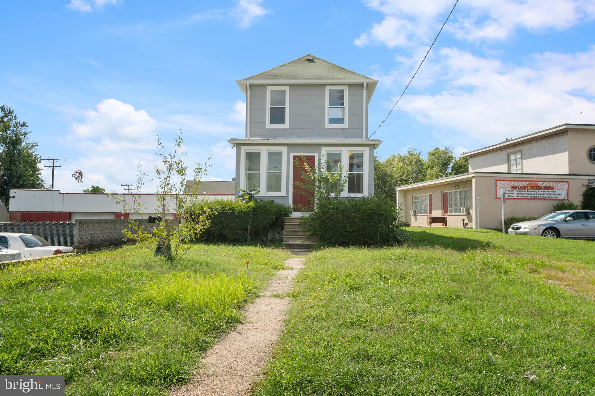 a front view of a house with a garden and yard