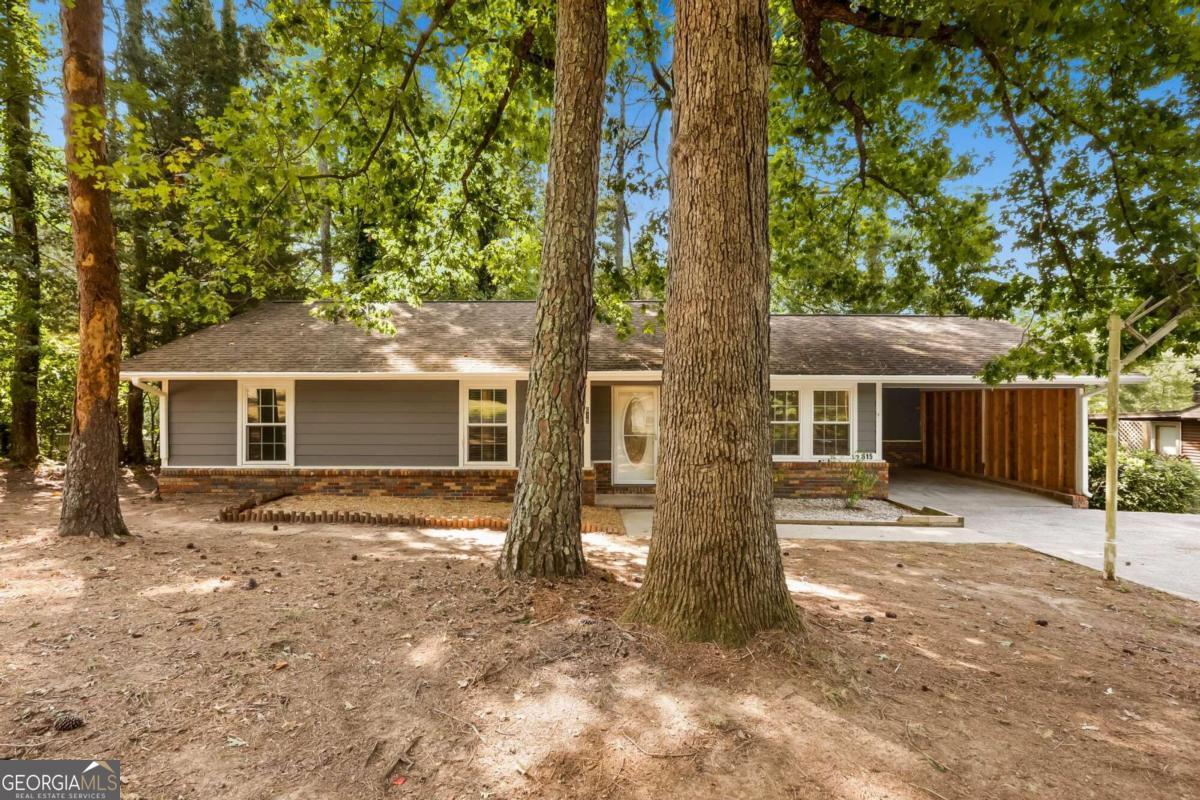 a view of a house with a tree in front of it