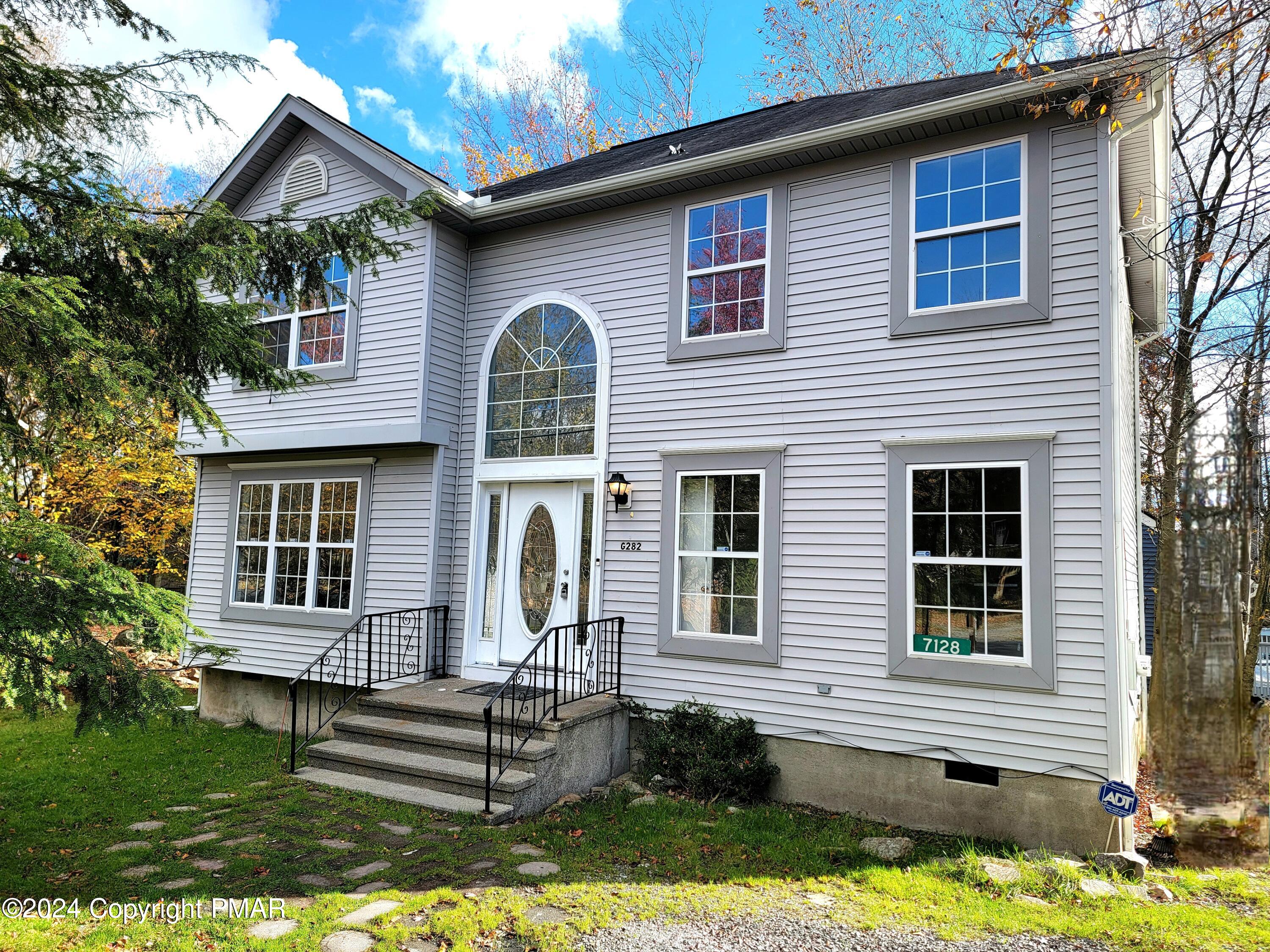 a front view of a house with a yard