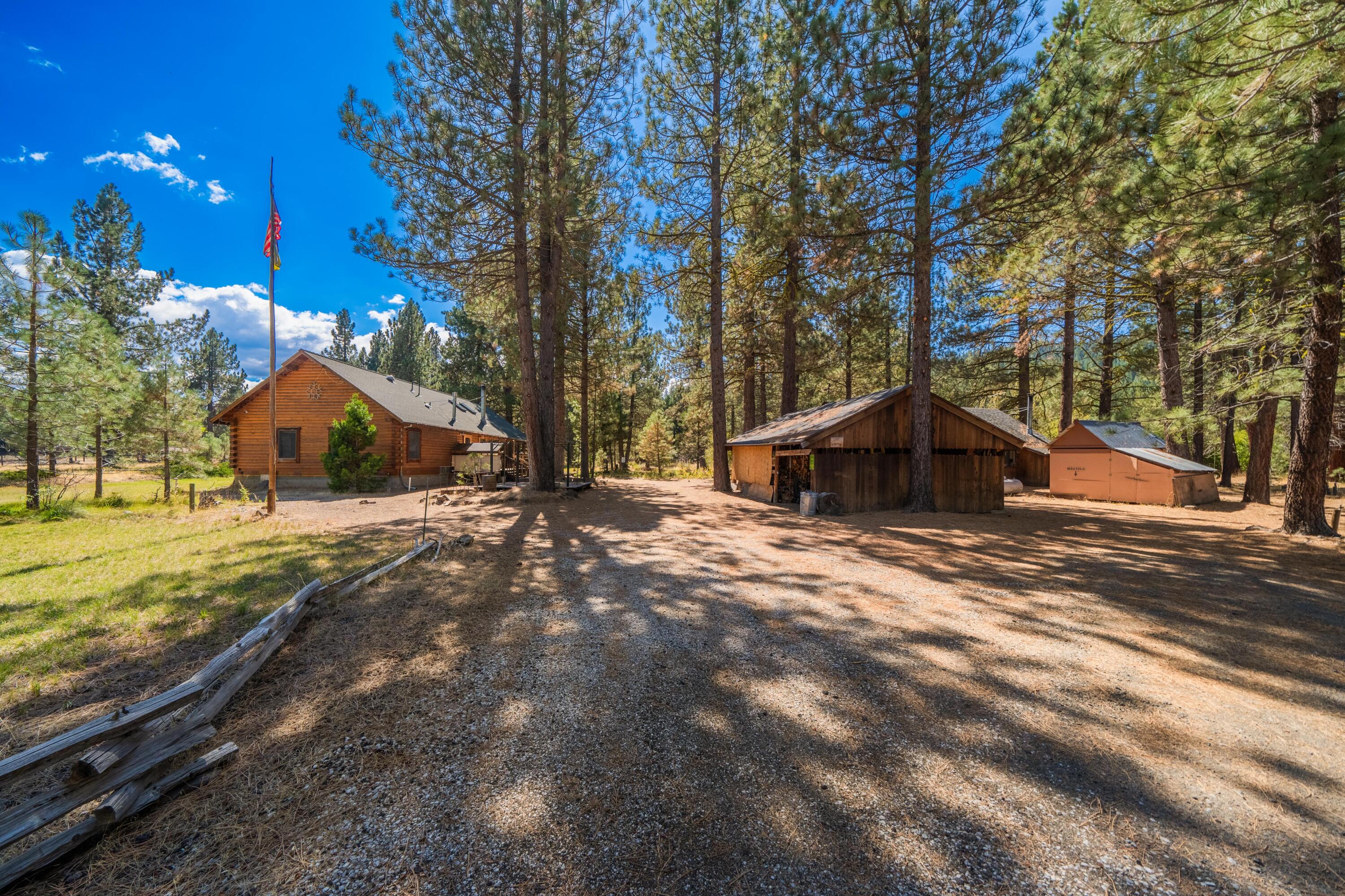 a wooden house with tall trees