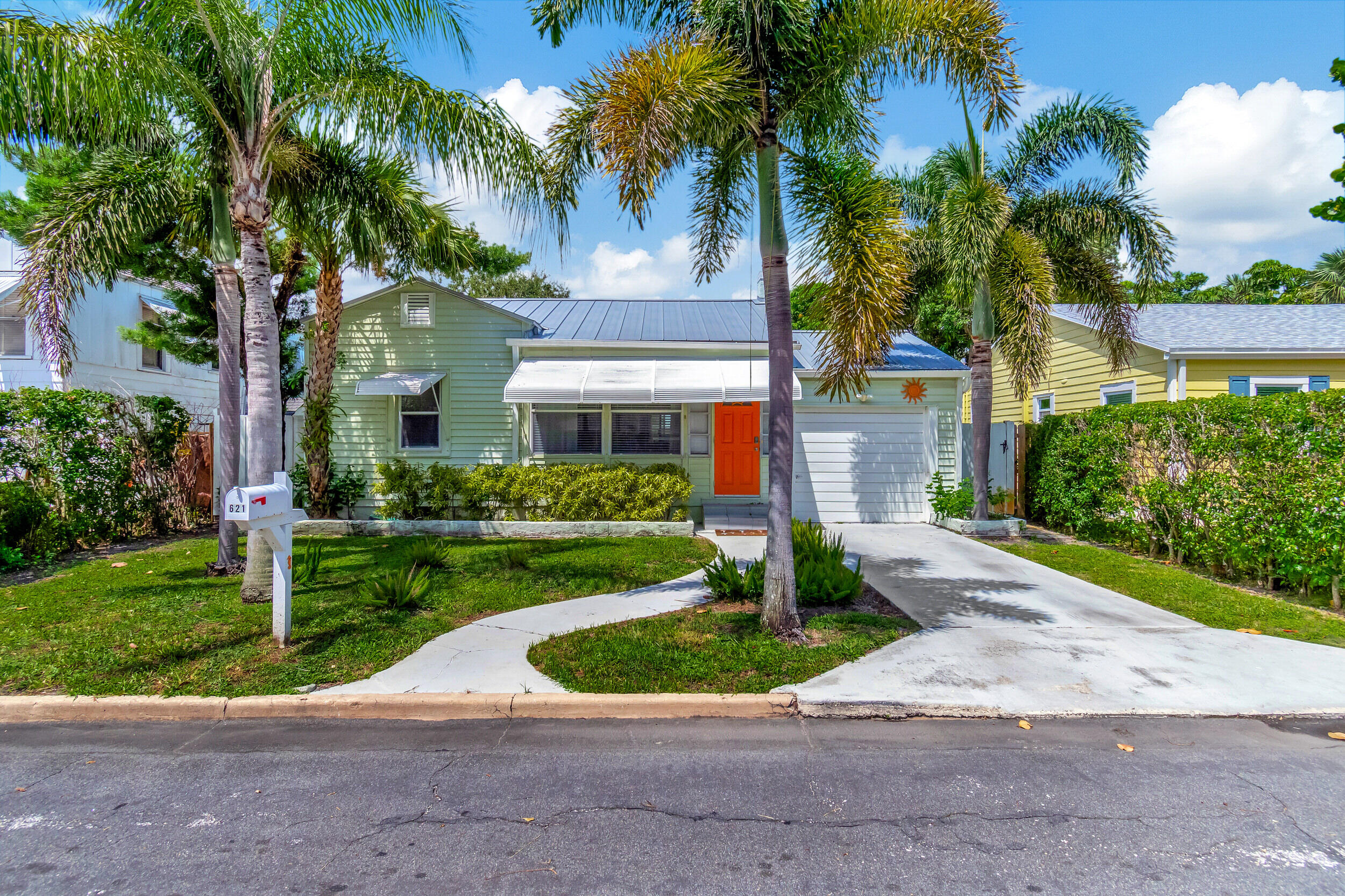 a front view of house with yard and green space