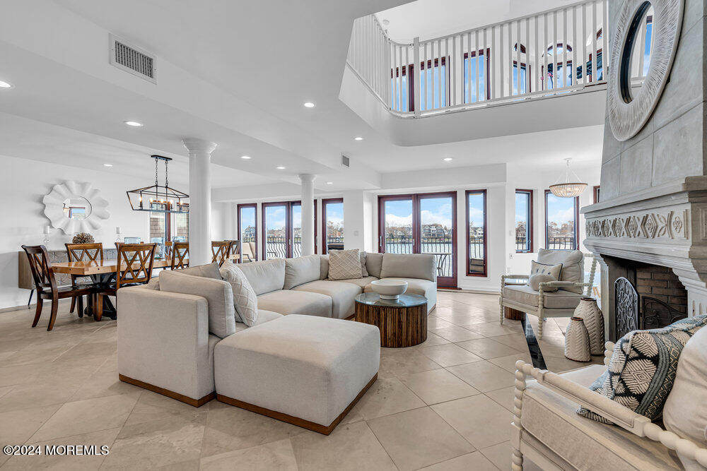 a living room with furniture a fireplace and a chandelier