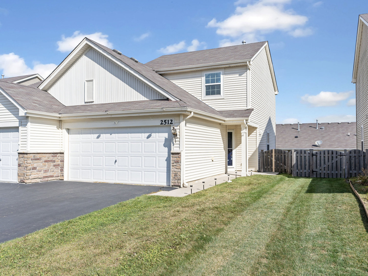 a view of a house with a yard and garage