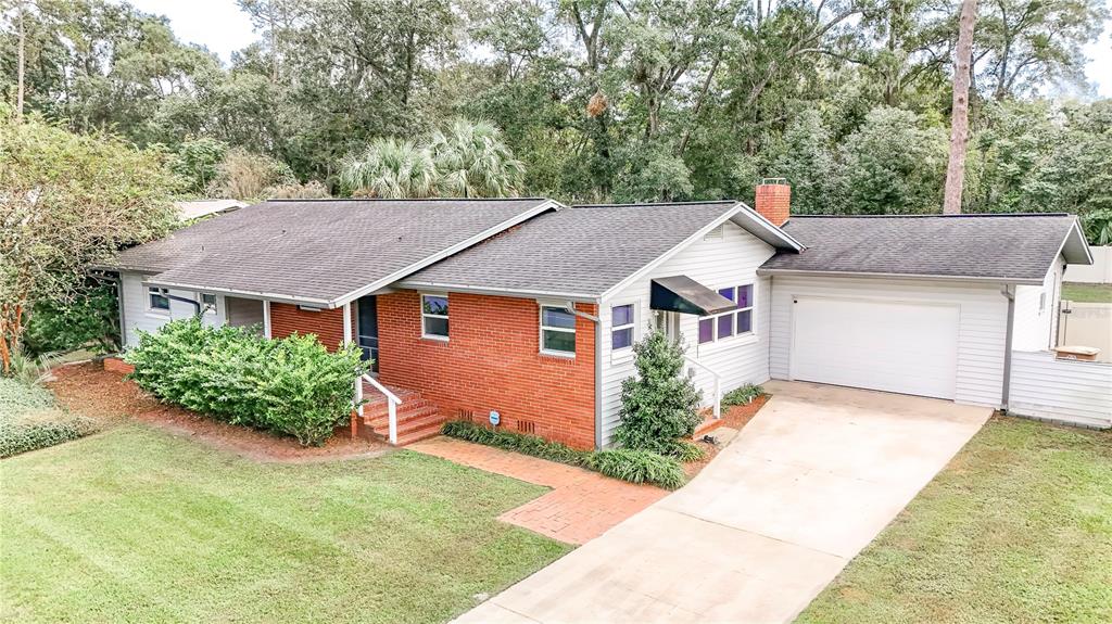 a aerial view of a house next to a yard