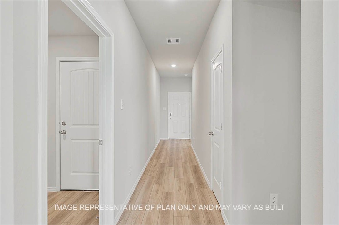 Hallway featuring light hardwood / wood-style floo