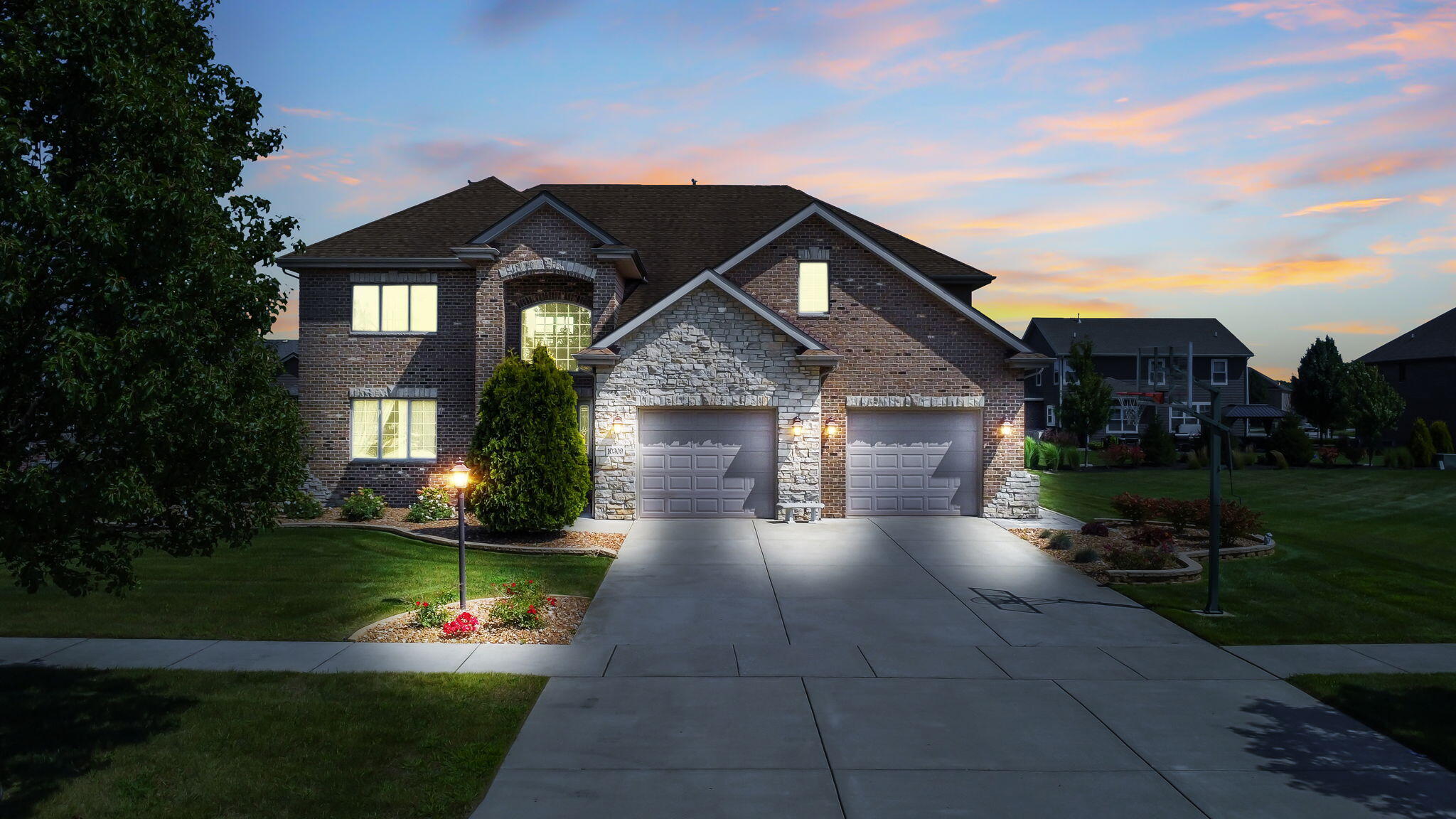 a front view of a house with a yard and garage