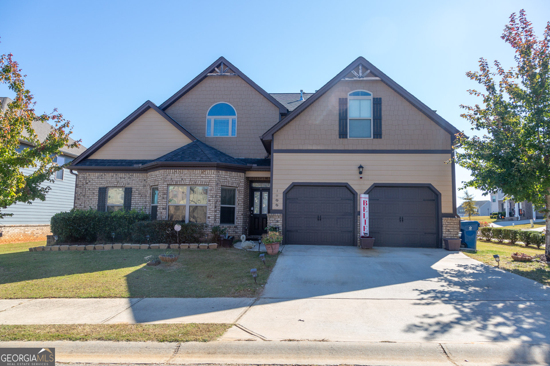 a front view of a house with a yard and garage