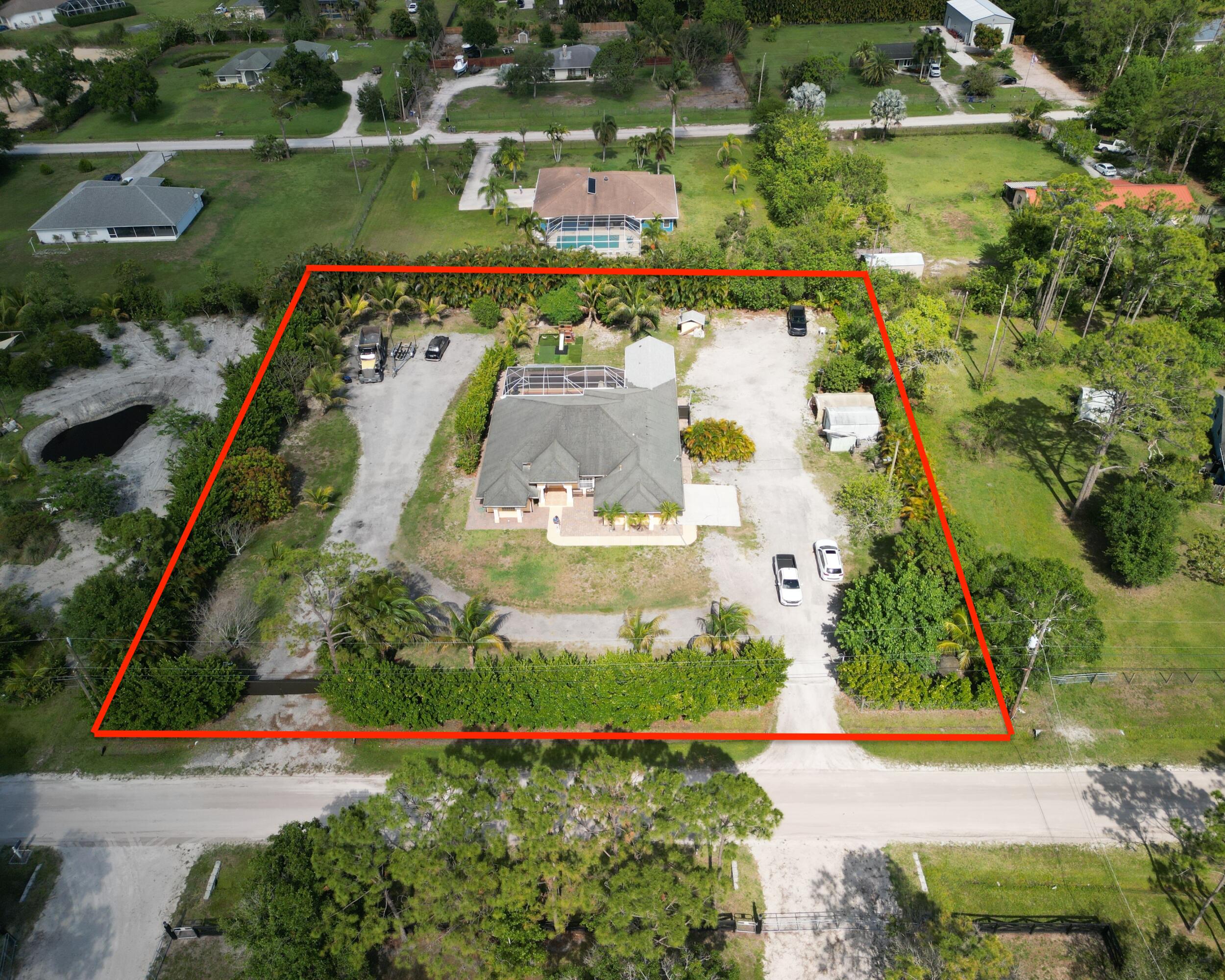 an aerial view of a residential houses with outdoor space and street view