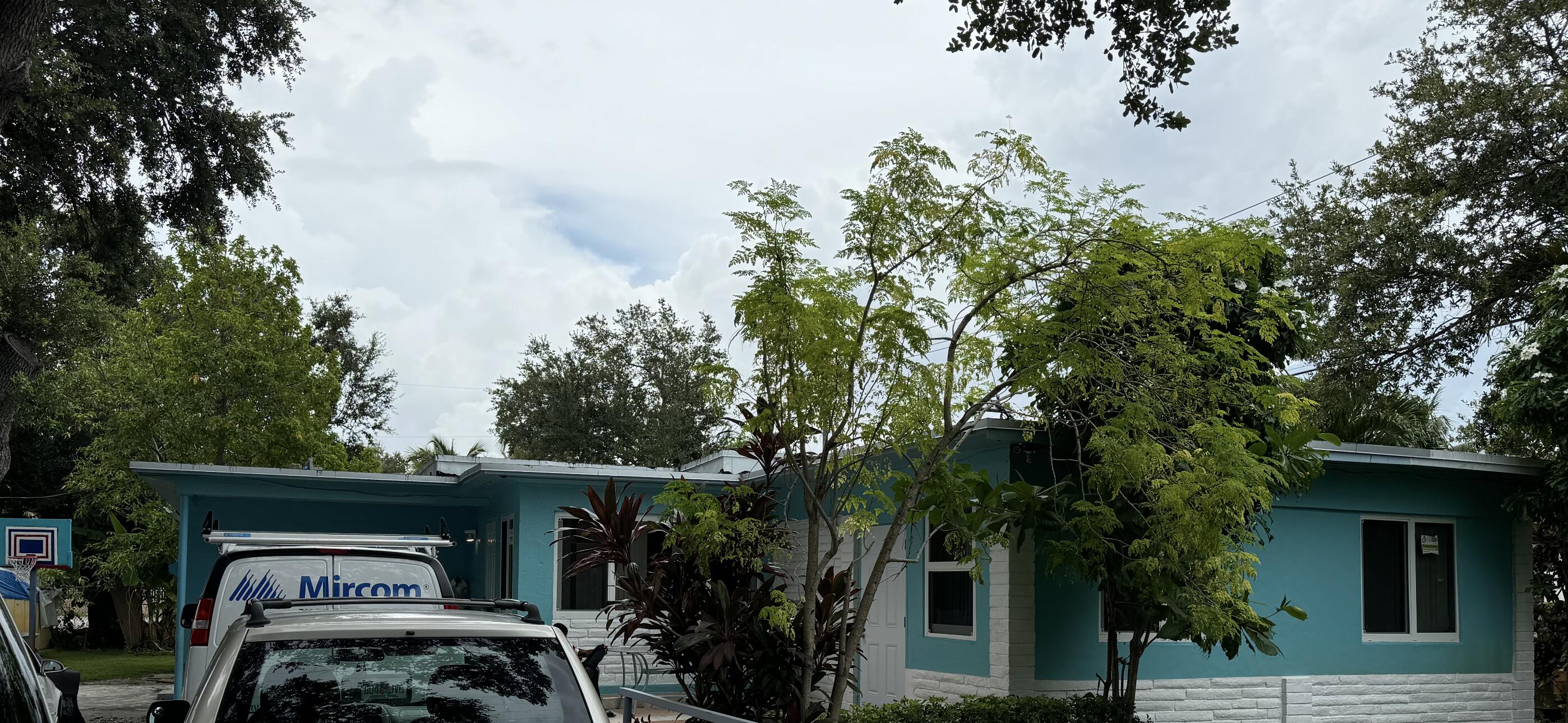 a view of roof deck with table and chairs and potted plants