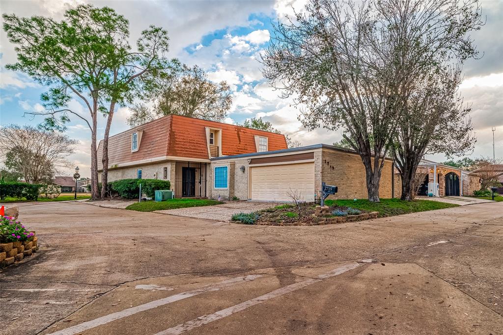 a front view of a house with a yard and a garage