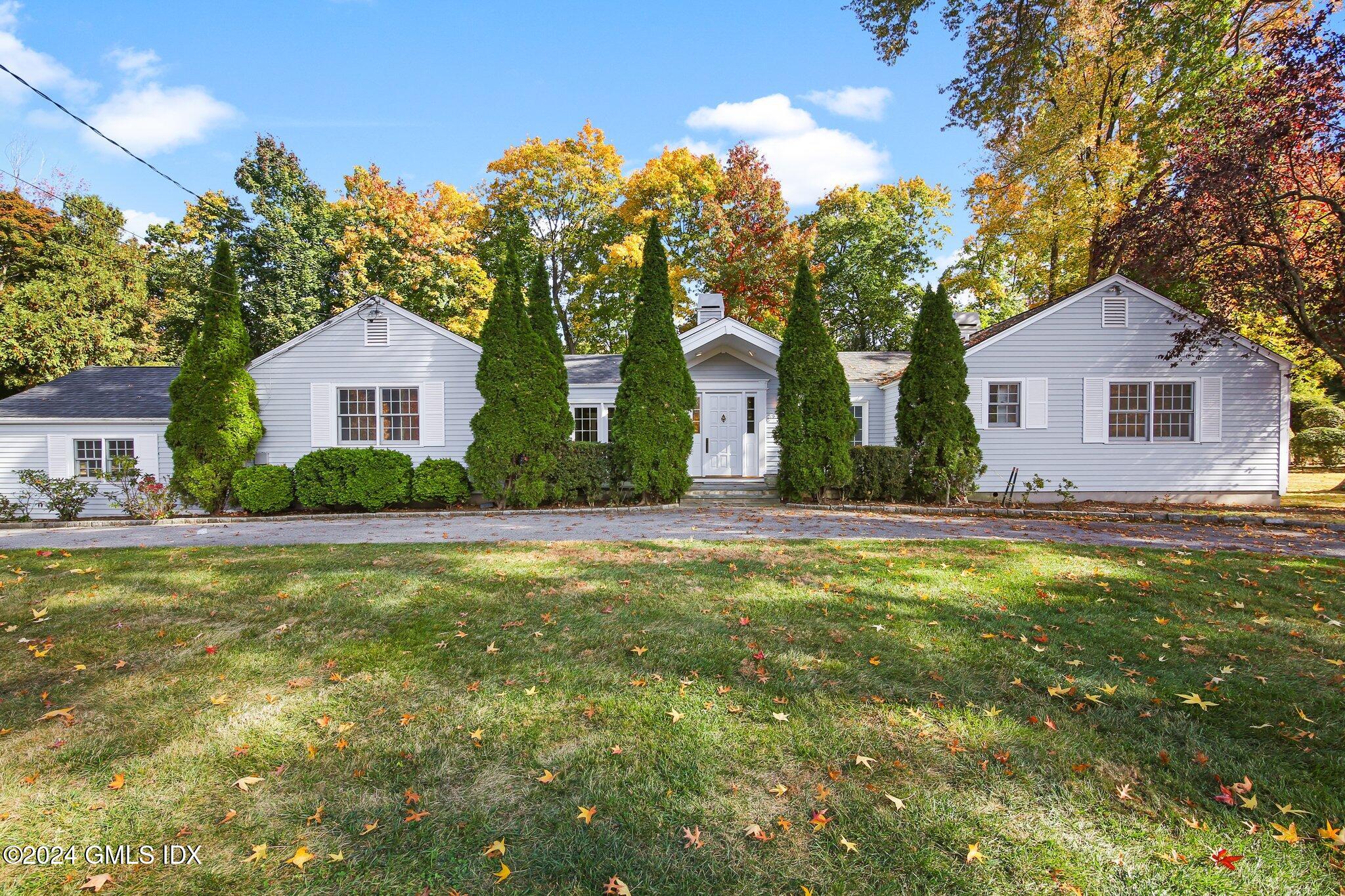 a front view of house with yard and green space