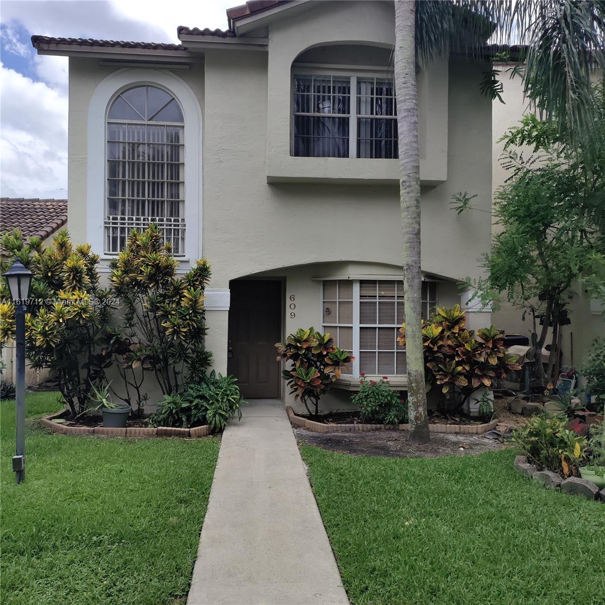 a front view of a house with garden