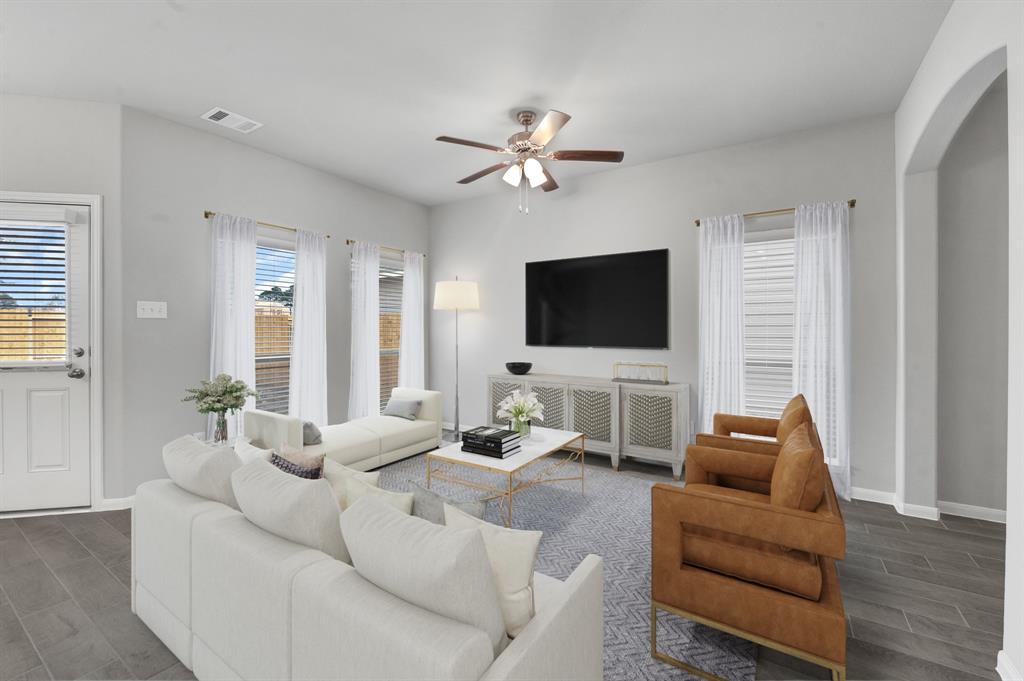 a living room with furniture and a flat screen tv