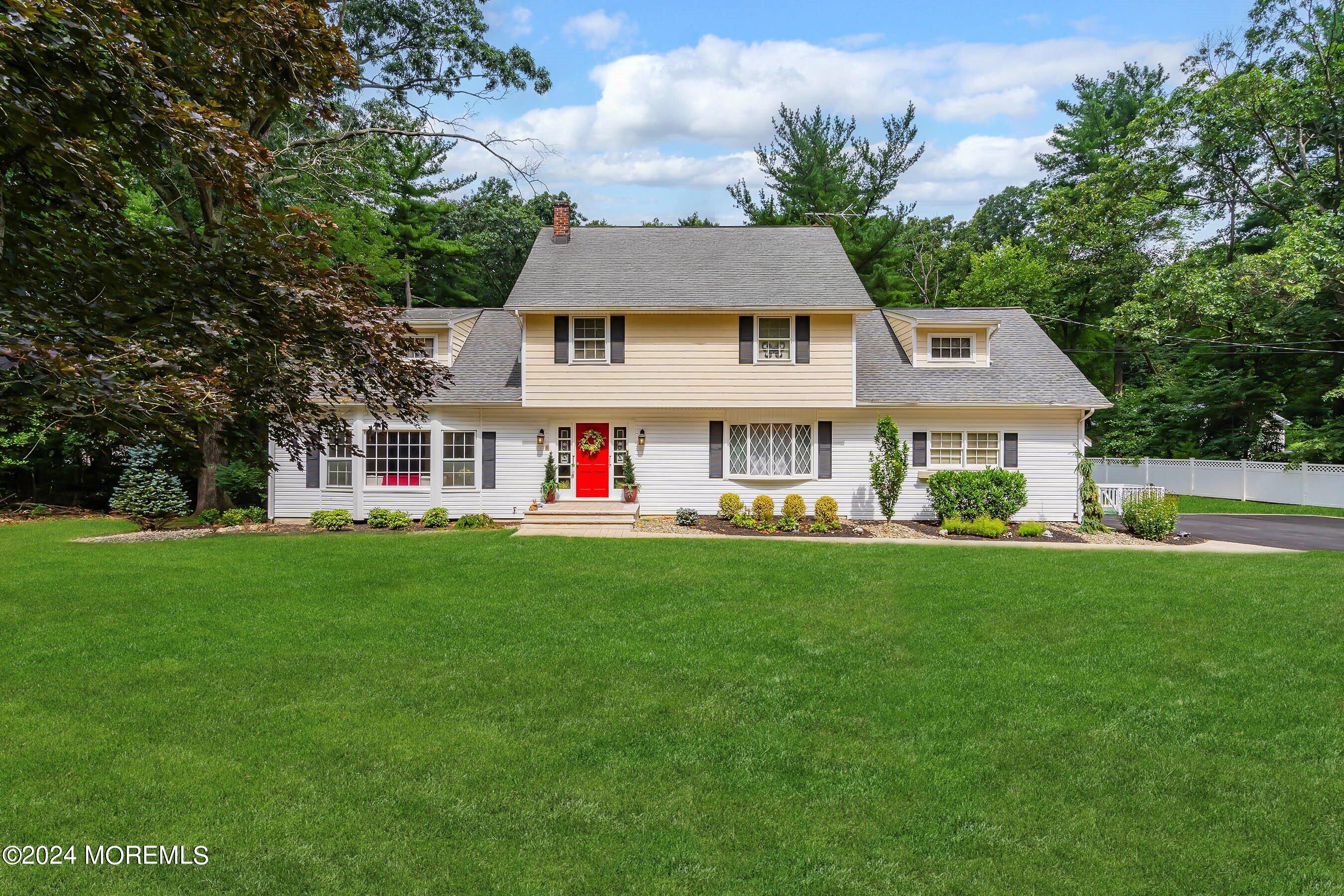 a front view of house with yard and green space