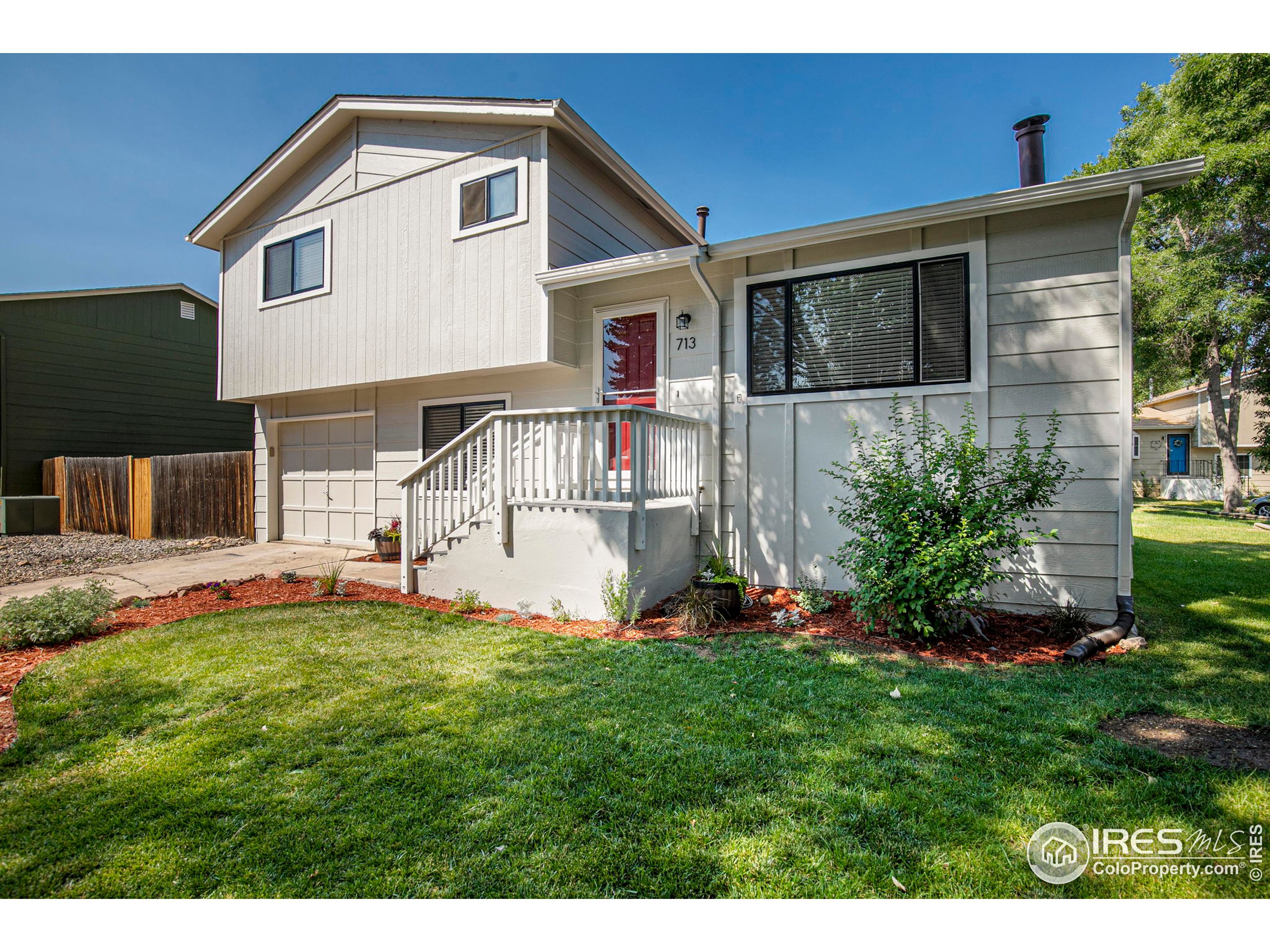 a front view of house with yard and outdoor seating