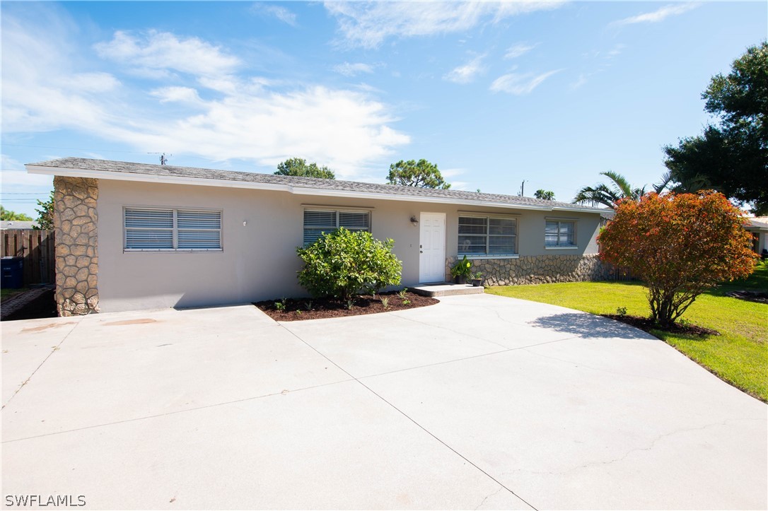 a view of a house with palm trees