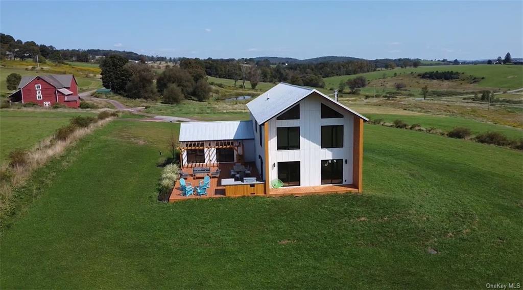 a view of a house with pool and a yard