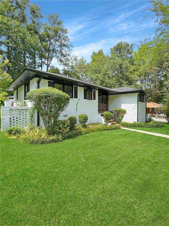 a front view of house with yard and green space