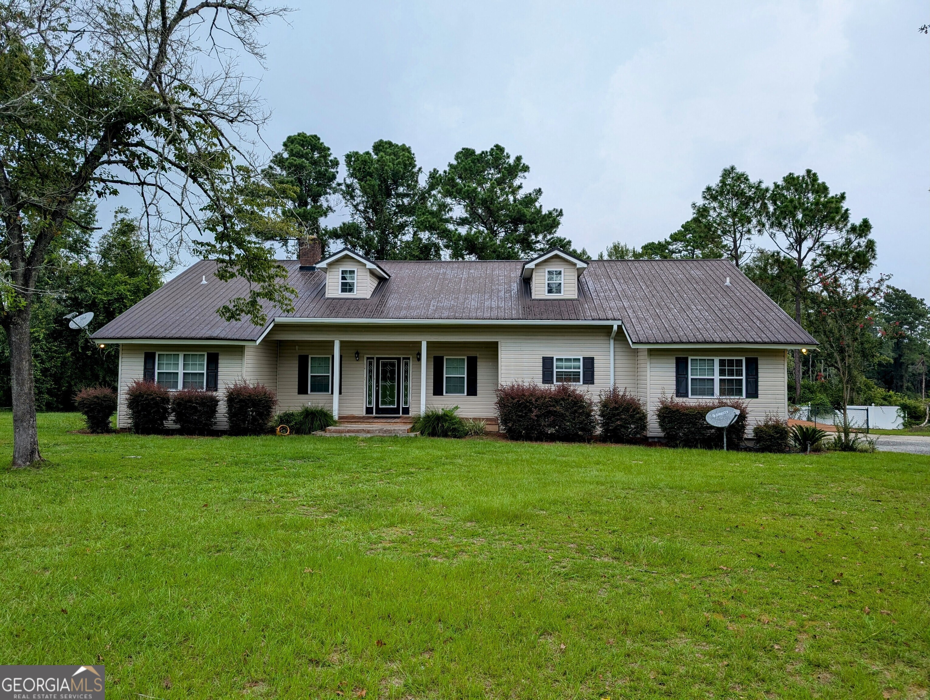 a front view of a house with a garden