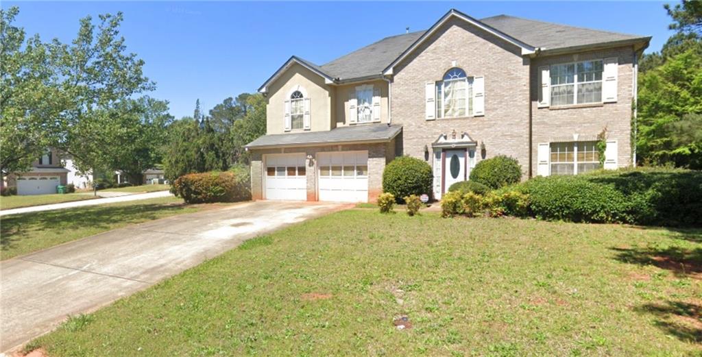 a front view of a house with a yard